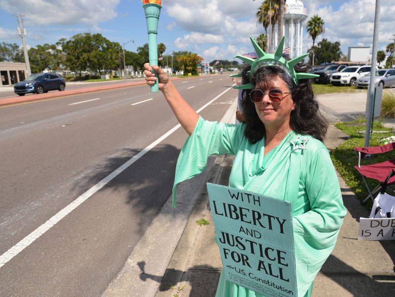 Dee Maynard dressed in her Statue of Liberty Costume, out on US 1. Saturday, Sept. 20 was a national day of action, ‘make billionaires pay’. The event at the intersection of 520 and US1 in Cocoa drew a large crowd. The event was hosted by Awake Brevard, Brevard Action Alliance, Stop Moms fort Liberty and Brevard Dems.