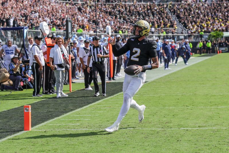 Sep 20, 2025; Orlando, Florida, USA; UCF Knights quarterback Tayven Jackson (2) scores during the first quarter against the North Carolina Tar Heels at the Bounce House Stadium. Mandatory Credit: Mike Watters-Imagn Images