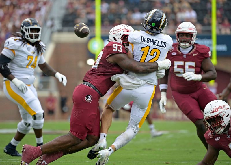 Sep 20, 2025; Tallahassee, Florida, USA; Kent State Golden Flashes quarterback Dru DeShields (12) is hit as he throws the ball by Florida State Seminoles defensive lineman Mandrell Desir (93) during the first half at Doak S. Campbell Stadium. Mandatory Credit: Melina Myers-Imagn Images