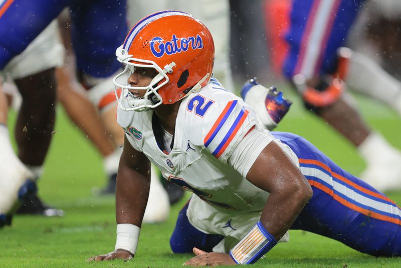 Sep 20, 2025; Miami Gardens, Florida, USA; Florida Gators quarterback DJ Lagway (2) watches after tossing the football against the Miami Hurricanes during the first quarter at Hard Rock Stadium. Mandatory Credit: Sam Navarro-Imagn Images