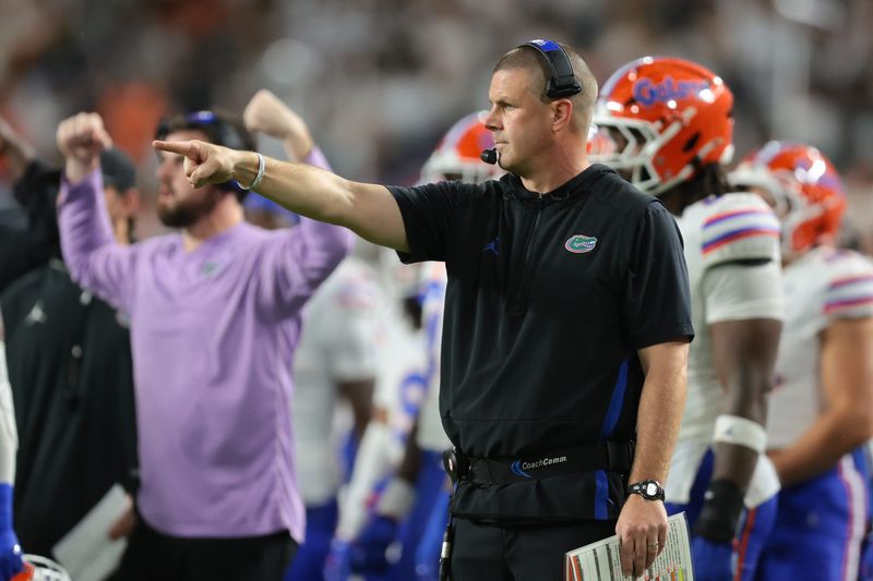 Sep 20, 2025; Miami Gardens, Florida, USA; Florida Gators head coach Billy Napier signals against the Miami Hurricanes during the second quarter at Hard Rock Stadium. Mandatory Credit: Sam Navarro-Imagn Images