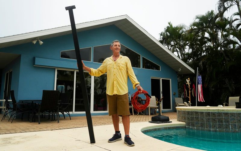 Fort Myers Beach resident Sam Lurie, photographed on September 17, 2025, is a Hurricane Ian survivor. During the hurricane his house flooded and he managed to swim out and tie himself to a pool cage beam that was still standing in his backyard using an extension cord as a rope,