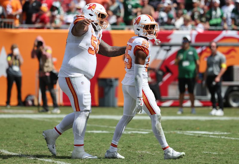 Sep 21, 2025; Tampa, Florida, USA; Tampa Bay Buccaneers cornerback Jacob Parrish (25) celebrates with defensive tackle Vita Vea (50) after he made a sack during the second quarter at Raymond James Stadium. Mandatory Credit: Kim Klement Neitzel-Imagn Images