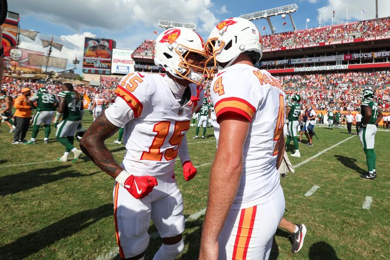 Sep 21, 2025; Tampa, Florida, USA; Tampa Bay Buccaneers kicker Chase McLaughlin (4) and wide receiver Tez Johnson (15) react after beating the New York Jets at Raymond James Stadium. Mandatory Credit: Nathan Ray Seebeck-Imagn Images