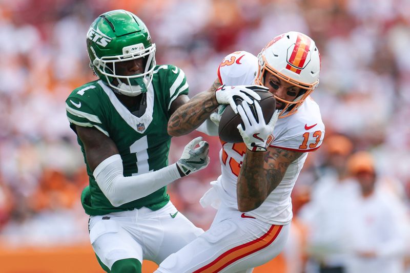 Sep 21, 2025; Tampa, Florida, USA; Tampa Bay Buccaneers wide receiver Mike Evans (13) catches pass defended boy New York Jets cornerback Sauce Gardner (1) in the third quarter at Raymond James Stadium. Mandatory Credit: Nathan Ray Seebeck-Imagn Images