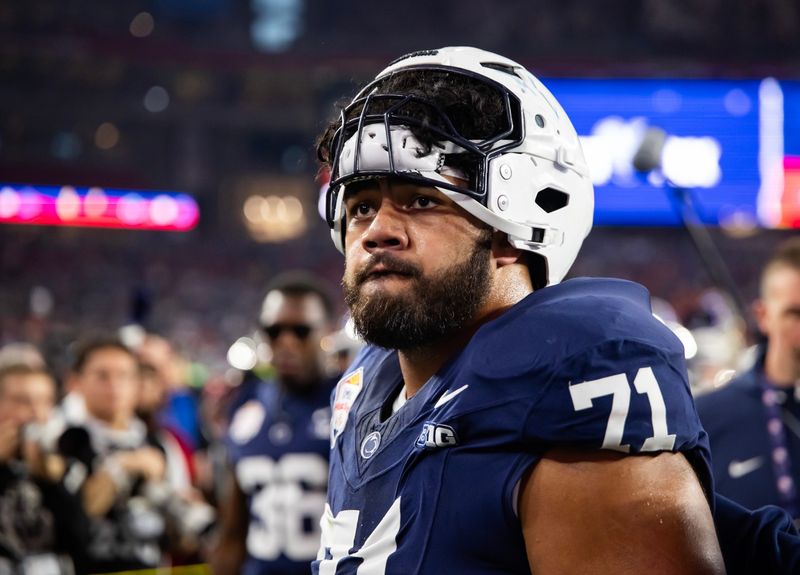 Dec 31, 2024; Glendale, AZ, USA; Penn State Nittany Lions offensive lineman Olaivavega Ioane (71) against the Boise State Broncos during the Fiesta Bowl at State Farm Stadium. Mandatory Credit: Mark J. Rebilas-Imagn Images