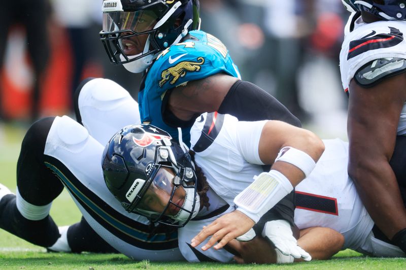 Houston Texans quarterback CJ. Stroud (7) is sacked by Jacksonville Jaguars defensive end Travon Walker (44) during the first quarter of an NFL football matchup at EverBank Stadium, Sunday, Sept. 21, 2025, in Jacksonville, Fla. The Jaguars defeated the Texans 17-10.