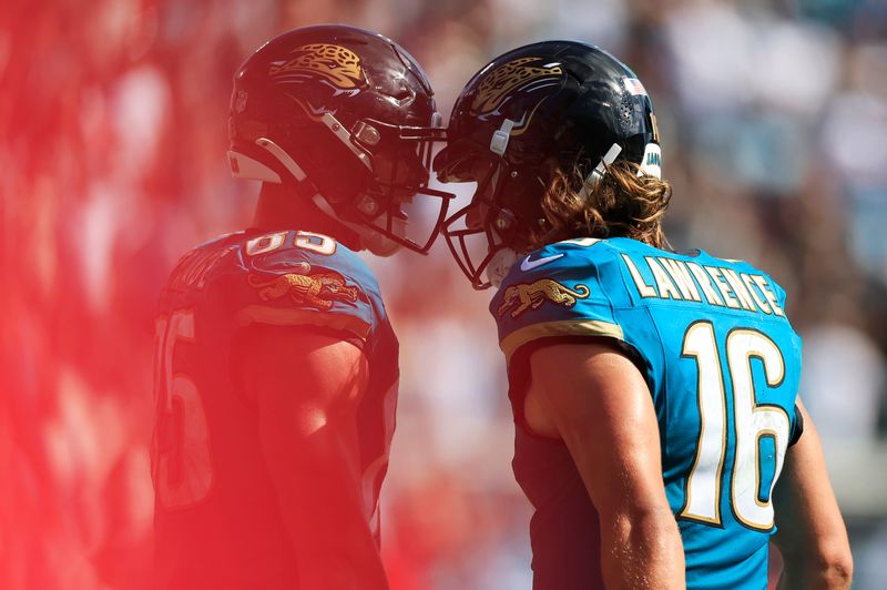 Jacksonville Jaguars quarterback Trevor Lawrence (16) and tight end Brenton Strange (85) celebrate a touchdown score during the fourth quarter of an NFL football matchup at EverBank Stadium, Sunday, Sept. 21, 2025, in Jacksonville, Fla. The Jaguars defeated the Texans 17-10.