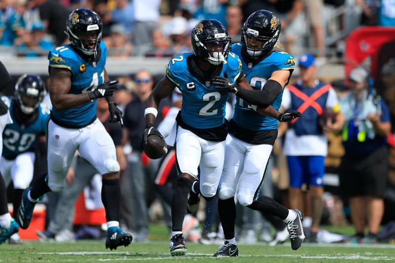 Jacksonville Jaguars cornerback Jourdan Lewis (2) celebrates his interception with safety Andrew Wingard (42), right, and defensive end Josh Hines-Allen (41), left, during the fourth quarter of an NFL football matchup at EverBank Stadium, Sunday, Sept. 21, 2025, in Jacksonville, Fla. The Jaguars defeated the Texans 17-10.