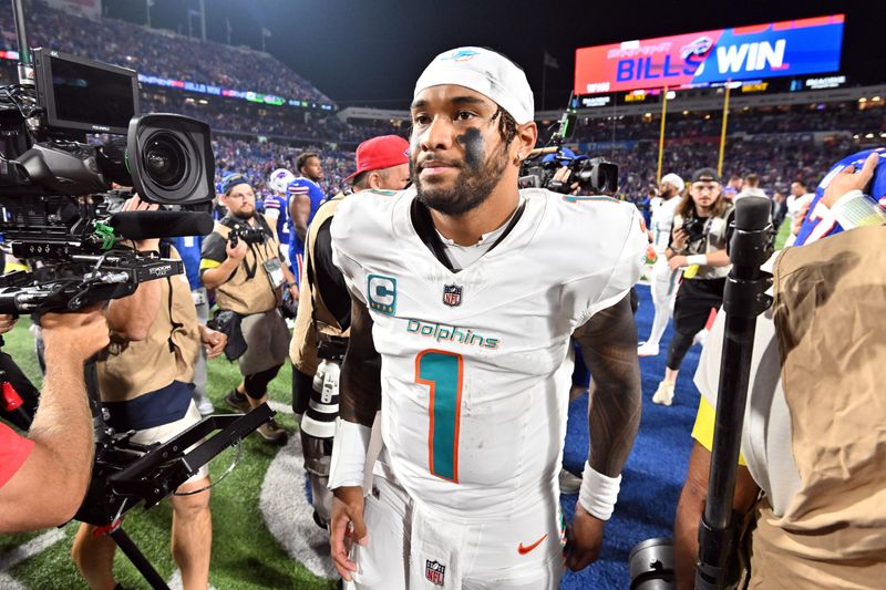 Sep 18, 2025; Orchard Park, New York, USA; Miami Dolphins quarterback Tua Tagovailoa (1) looks on after the game against the Buffalo Bills at Highmark Stadium. Mandatory Credit: Mark Konezny-Imagn Images