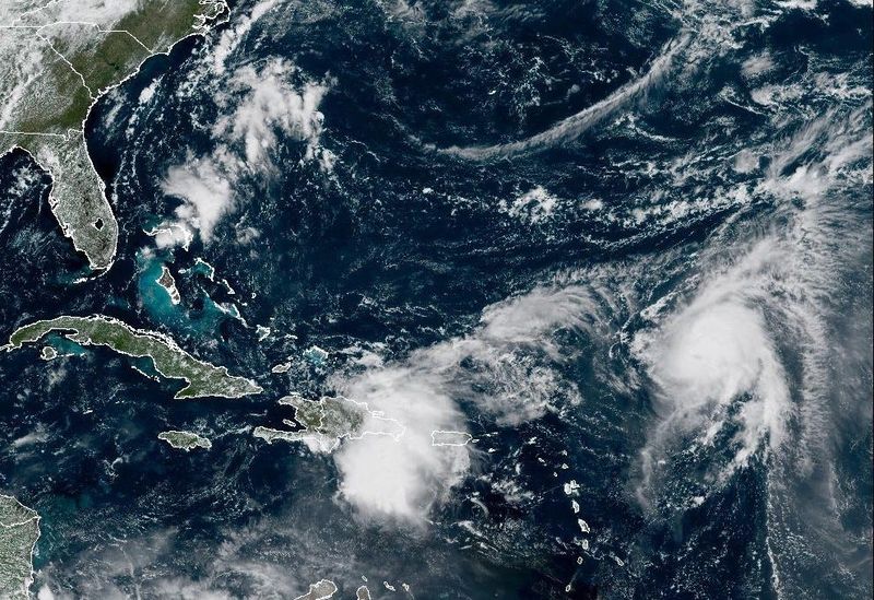 This NOAA satellite image shows Tropical Storm Humberto at right and a tropical wave to the left over Hispaniola, the island that includes the Dominican Republic and Haiti. The two systems are drawing close scrutiny as meteorologists try to determine what their impacts could be in the coming days.