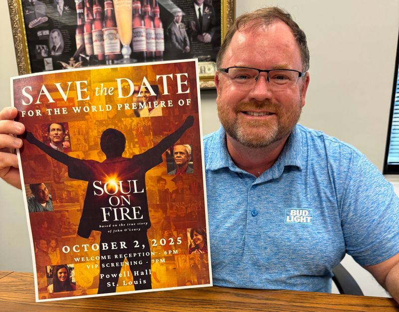 Daytona Beverages President Chris Bowler holds a poster for the upcoming movie about one of his best friends from childhood, John O'Leary, on Monday, Sept. 15, 2025. O'Leary survived a near-death experience when he was burned on 100% of his body in a house fire at age 9 and went on to a successful career as a motivational speaker and best-selling author. Bowler and his wife Maja are co-executive producers of the feature film starring John Corbett and William H. Macy.