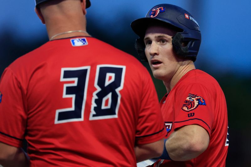 Jacksonville Jumbo Shrimp runner Jacob Berry speaks with manager David Carpenter during the Sept. 25 Game 3 against Scranton/Wilkes-Barre. Berry's home run lifted Jacksonville to its first overall Triple-A championship.