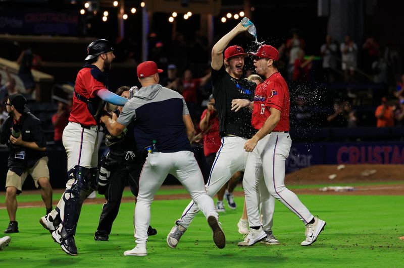 Jacksonville Jumbo Shrimp pitcher Adam Mazur (1), center left, douses pitcher Josh White (6) with water as catcher Joe Mack (8) looks on after the game of Game 3 of an MiLB International League Championship Series at VyStar Ballpark Thursday, Sept. 25, 2025 in Jacksonville, Fla. The Jacksonville Jumbo Shrimp defeated the Scranton/Wilkes-Barre RailRiders 7-4 and took home the title in a best-of-three game series. [Corey Perrine/Florida Times-Union]