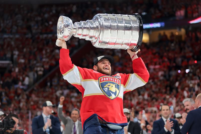 Jun 17, 2025; Sunrise, Florida, USA; Florida Panthers center Aleksander Barkov (16) hoists the Stanley Cup after winning game six of the 2025 Stanley Cup Final against the Edmonton Oilers at Amerant Bank Arena. Mandatory Credit: Sam Navarro-Imagn Images