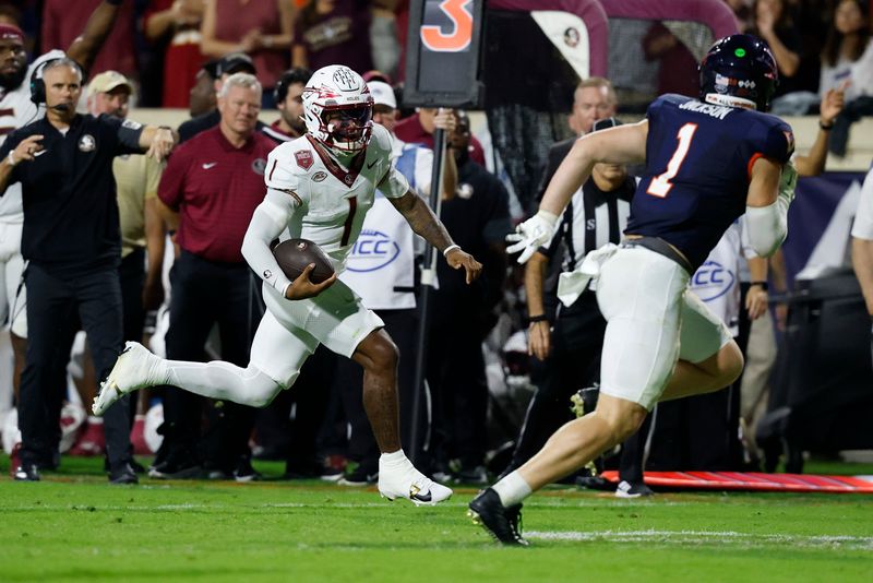 Sep 26, 2025; Charlottesville, Virginia, USA; Florida State Seminoles quarterback Tommy Castellanos (1) runs with the ball as Virginia Cavaliers linebacker James Jackson (1) chases during the second quarter at Scott Stadium. Mandatory Credit: Geoff Burke-Imagn Images