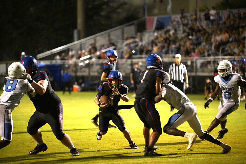 King's Academy's Roman Driggers shoots the gap on his way to scoring a touchdown against Inlet Grove on Sept. 26, 2025.
