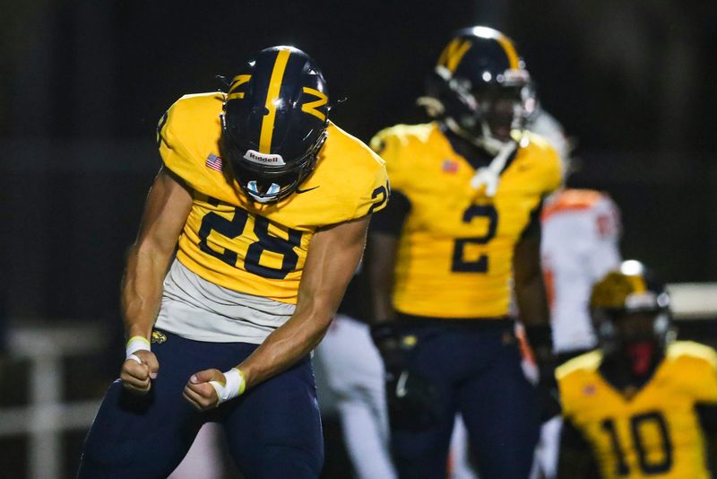 The Naples Golden Eagles compete against the Dunbar Tigers in a Class 4A District 12 game at Staver Field in Naples, Fla., on Friday, Sept. 26, 2025. Naples won 21-0.
