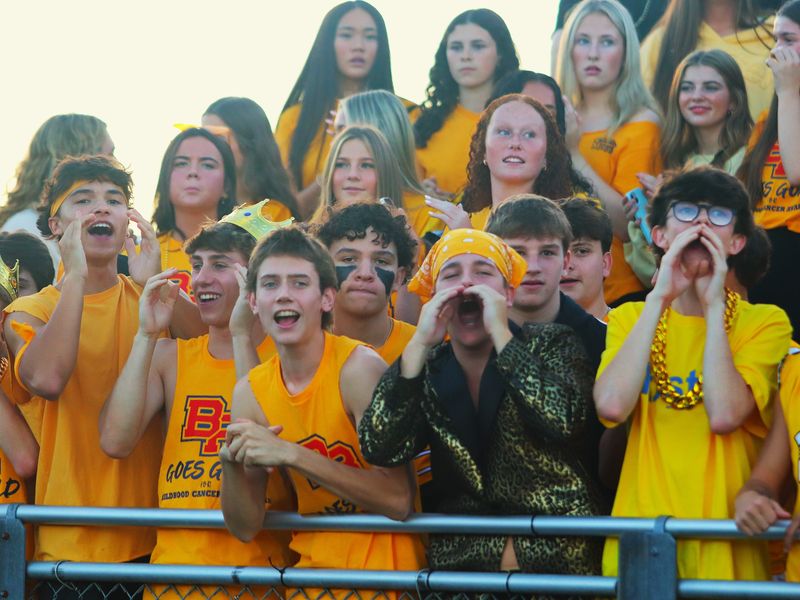 The Bridgewater-Raynham student section, wearing gold for childhood cancer awareness, cheer on the Trojans during a non-league game against Middleboro on Sept. 26, 2025.
