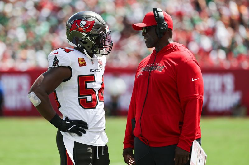 Sep 28, 2025; Tampa, Florida, USA; Tampa Bay Buccaneers outside linebacker Lavonte David (54) speaks with head coach Todd Bowles during the second quarter at Raymond James Stadium. Mandatory Credit: Kim Klement Neitzel-Imagn Images