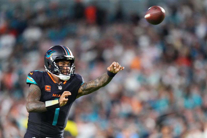 Sep 29, 2025; Miami Gardens, Florida, USA; Miami Dolphins quarterback Tua Tagovailoa (1) throws the ball against the New York Jets during the second half at Hard Rock Stadium. Mandatory Credit: Rich Storry-Imagn Images