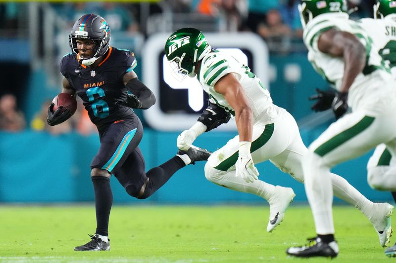 Sep 29, 2025; Miami Gardens, Florida, USA; Miami Dolphins wide receiver Malik Washington (6) makes a catch against New York Jets cornerback Brandon Stephens (21) during the first half at Hard Rock Stadium. Mandatory Credit: Rich Storry-Imagn Images
