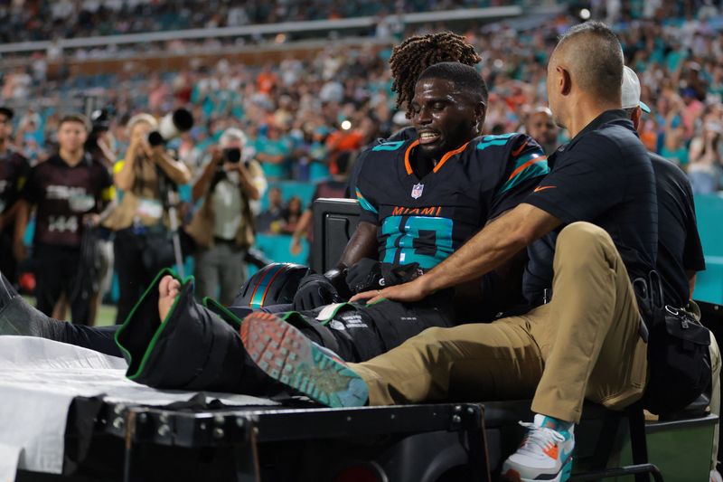 Sep 29, 2025; Miami Gardens, Florida, USA; Miami Dolphins wide receiver Tyreek Hill (10) reacts after being placed on a medical cart against the New York Jets during the second half at Hard Rock Stadium. Mandatory Credit: Sam Navarro-Imagn Images