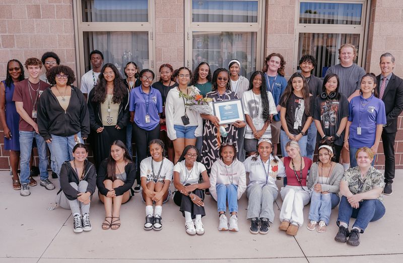 Booker High School teacher Khea Knight attracts a crowd, including Principal Rachel Shelley, far left, and Superintendent Terry Connor, far right, after receiving the Barancik Foundation’s Ripple Effect Teacher Award.