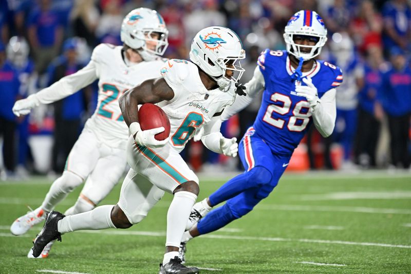 Sep 18, 2025; Orchard Park, New York, USA; Miami Dolphins wide receiver Malik Washington (6) runs against Buffalo Bills defensive back Sam Franklin Jr. (28) in the second half at Highmark Stadium. Mandatory Credit: Mark Konezny-Imagn Images