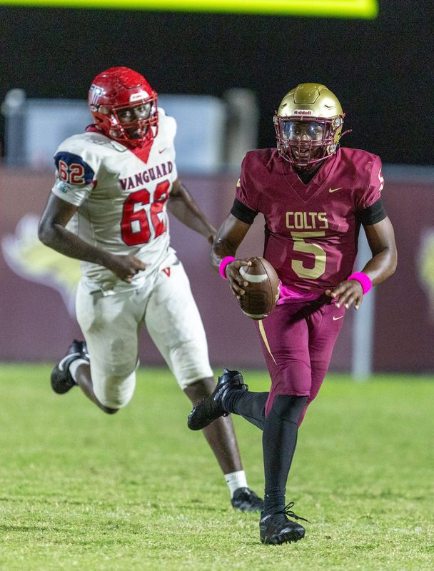 North Marion quarterback Matt Dial (5) gets chased down by Vanguard Dylan Harris (62) during an FHSAA football game at North Marion High School in Citra, FL on Friday, October 3, 2025. [Alan Youngblood/Ocala Star-Banner]