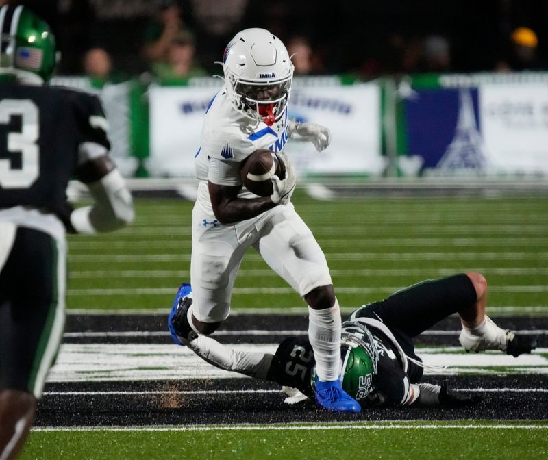 IMG running back Eric McFarland III (#3) runs over Venice defensive back Malec Borrelli (#25). The Venice Indians hosted the IMG Academy Ascenders National team Friday evening Sept. 3, 2025.