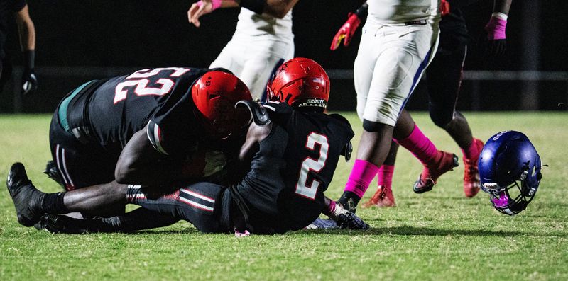 Cornelius Tims , left, and Jadell Carter sack Cypress Lake quarterback Jaydon Henderson during a game against Cypres Lake at South Fort Myers on Friday, Oct. 3, 2025. South won.