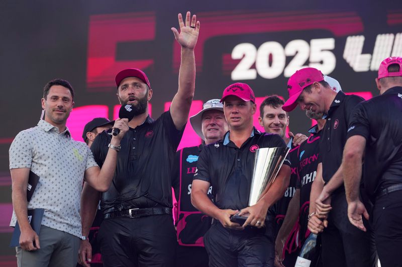 Aug 24, 2025; Detroit, Michigan, USA; Jon Rahm and teammates of Legion XIII celebrate with the trophy after the finals of the LIV Golf Michigan Team Championship at The Cardinal at Saint John's Resort. Mandatory Credit: Aaron Doster-Imagn Images