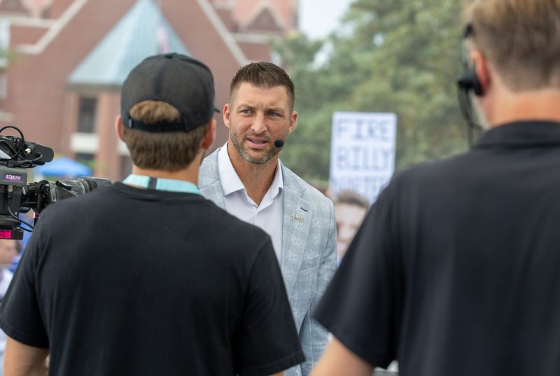 Former Gator quarterback Tim Tebow talks with crew of the ESPN SEC Nation panel do their show from Plaza of the Americas in Gainesville, FL on Saturday, October 4, 2025. [Alan Youngblood/Gainesville Sun]