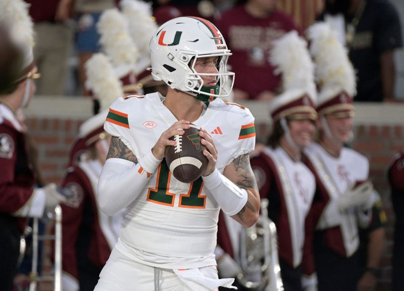 Miami Hurricanes quarterback Carson Beck (11) warms up before a game Oct. 4, 2025, against the Florida State Seminoles at Doak S. Campbell Stadium in Tallahassee, Florida. Mandatory Credit: Melina Myers-Imagn Images