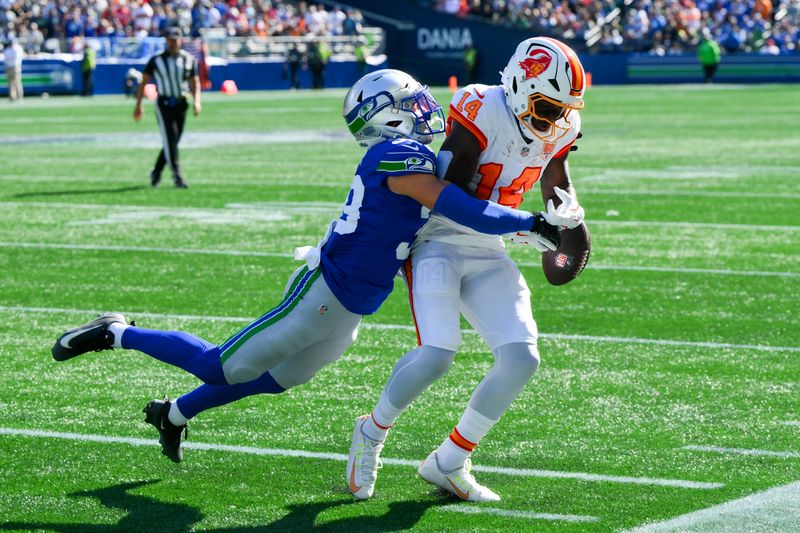 Oct 5, 2025; Seattle, Washington, USA; Seattle Seahawks safety Ty Okada (39) breaks up a pass to Tampa Bay Buccaneers wide receiver Chris Godwin Jr. (14) during the first half at Lumen Field. Mandatory Credit: Steven Bisig-Imagn Images