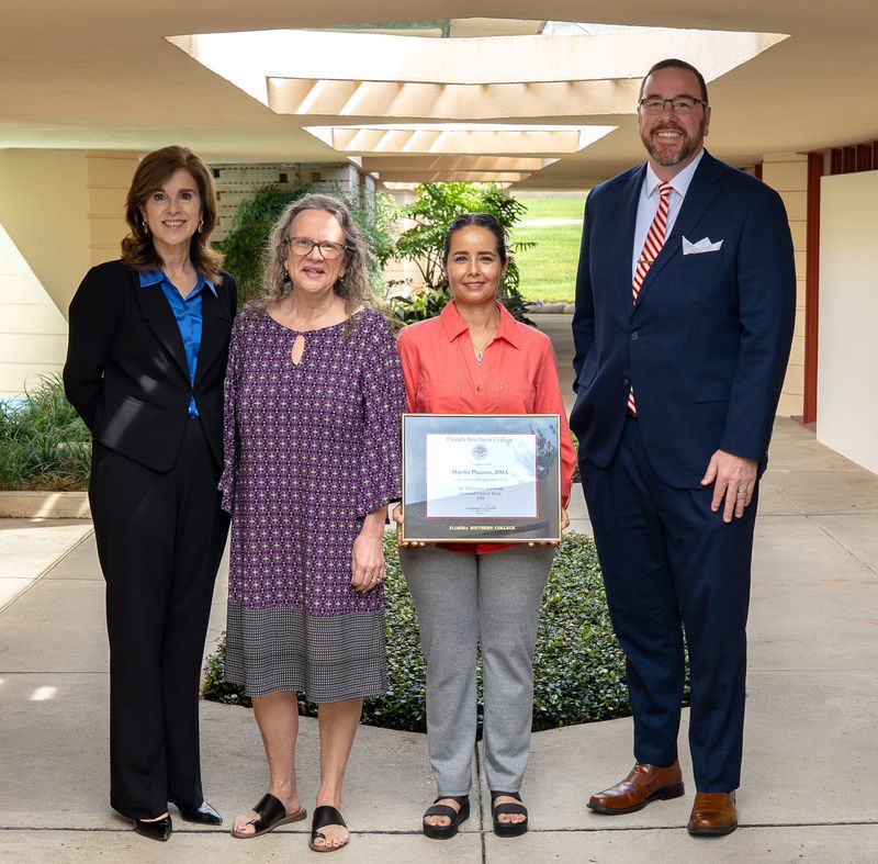 Martha Placeres, second from right, has been named the Wilhelmina MacDonald Endowed Faculty Chair in Music at Florida Southern College. She is shown with Provost Tracey Tedder, far left, and FSC President Jeremy Martin, right.