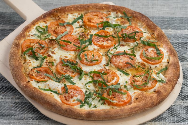 A Margherita pizza, as served at Piesanos Stone Fired Pizza. A new location celebrates its grand opening in The Villages at Southern Trace (next to Costco) on Oct. 13, 2025.
