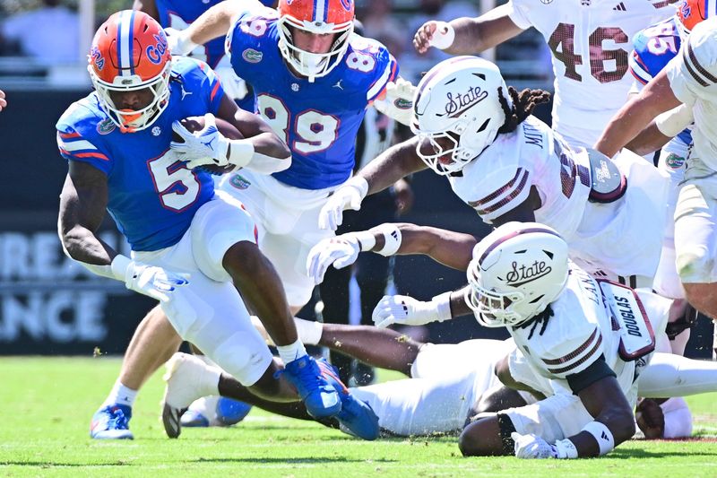 Sep 21, 2024; Starkville, Mississippi, USA; Florida Gators running back Treyaun Webb (5) runs the ball against the Mississippi State Bulldogs during the second quarter at Davis Wade Stadium at Scott Field. Mandatory Credit: Matt Bush-Imagn Images