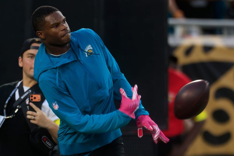 Jacksonville Jaguars wide receiver Travis Hunter (12) tosses a ball back before an NFL football matchup at EverBank Stadium, Monday, Oct. 6, 2025, in Jacksonville, Fla. [Corey Perrine/Florida Times-Union]