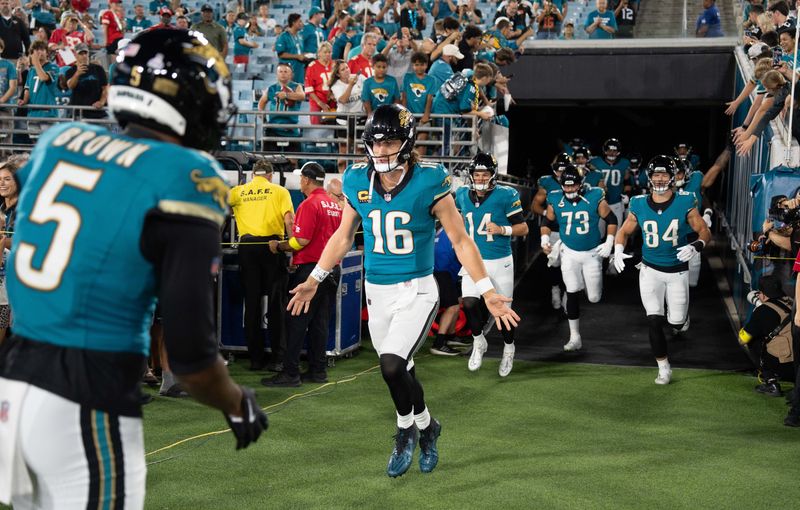 Jacksonville Jaguars wide receiver Dyami Brown (5) greets his teammates and Jacksonville Jaguars quarterback Trevor Lawrence (16) as they come out to warm up before an Monday Night NFL football game at EverBank Stadium, Monday, Oct. 6, 2025, in Jacksonville, Fla. [Doug EngleFlorida Times-Union]