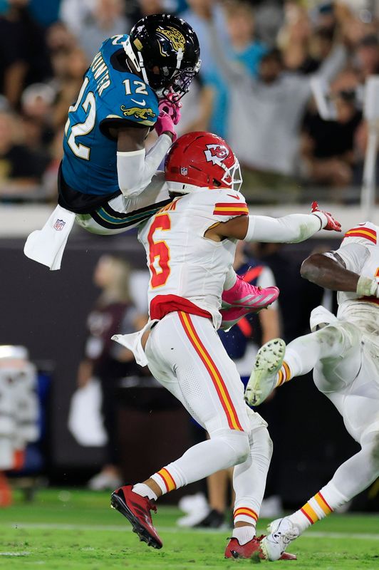 Jacksonville Jaguars wide receiver Travis Hunter (12) hauls in a reception against Kansas City Chiefs safety Bryan Cook (6) during the third quarter of an NFL football matchup at EverBank Stadium, Monday, Oct. 6, 2025, in Jacksonville, Fla. The Jacksonville Jaguars edged the Kansas City Chiefs 31-28. [Corey Perrine/Florida Times-Union]