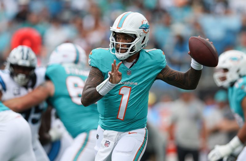 Oct 5, 2025; Charlotte, North Carolina, USA; Miami Dolphins quarterback Tua Tagovailoa (1) throws a pass during the first quarter against the Carolina Panthers at Bank of America Stadium. Mandatory Credit: Cory Knowlton-Imagn Images