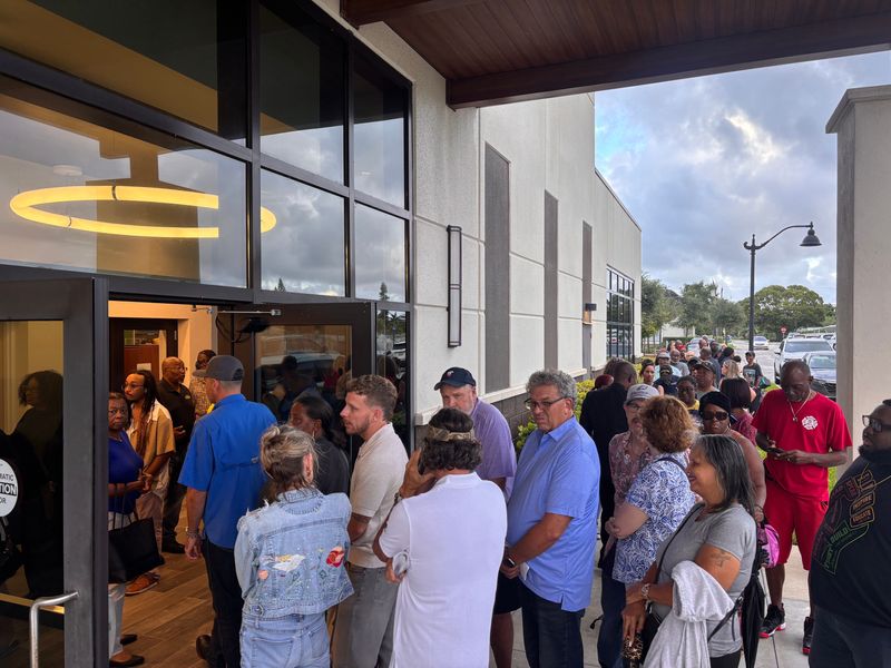 People line up at Boynton Beach City Hall ahead of the Tuesday, Oct. 7 meeting to voice a dissenting opinion on Commissioner Thomas Turkin's idea of a statue in the city to honor the late political activist Charlie Kirk.