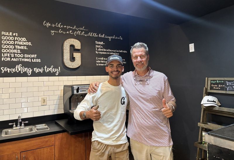 Goodies Eatery new owner Will Johnson, left, and former owner John Henningsen in the new location at 106 E. College Ave.
