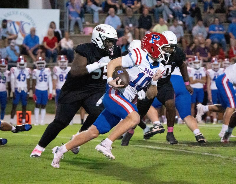 Patriots quarterback Brooks Washington (10) keeps the ball during the Pace vs Tate football game at Tate High School in Cantonment on Oct. 10, 2025.