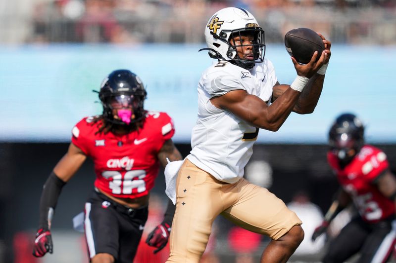 Oct 11, 2025; Cincinnati, Ohio, USA; UCF Knights running back Jaden Nixon (5) makes a catch against the Cincinnati Bearcats in the second half at Nippert Stadium. Mandatory Credit: Aaron Doster-Imagn Images