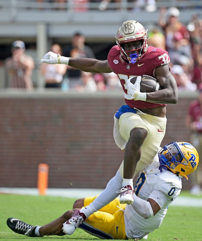 Oct 11, 2025; Tallahassee, Florida, USA; Florida State Seminoles running back Ousmane Kromah (32) is tackled by Pittsburgh Panthers linebacker Braylan Lovelace (0) during the second half at Doak S. Campbell Stadium. Mandatory Credit: Melina Myers-Imagn Images
