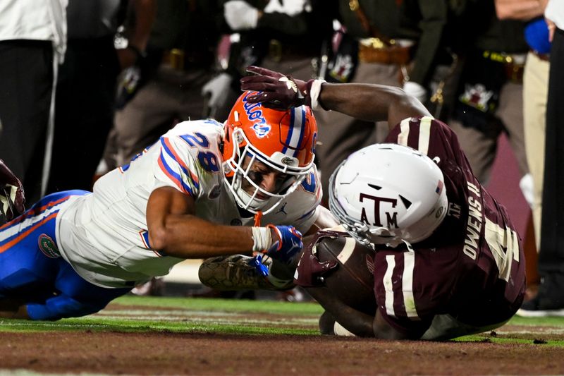 Oct 11, 2025; College Station, Texas, USA; Texas A&M Aggies running back Rueben Owens II (4) scores a touchdown during the fourth quarter as Florida Gators cornerback Devin Moore (28) attempts a tackle at Kyle Field. Mandatory Credit: Maria Lysaker-Imagn Images