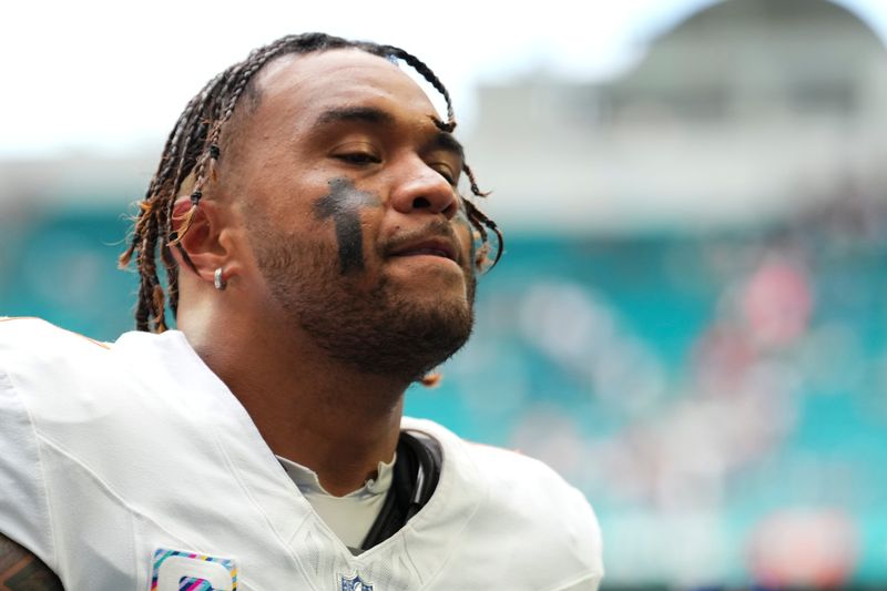 Oct 12, 2025; Miami Gardens, Florida, USA; Miami Dolphins quarterback Tua Tagovailoa (1) leaves the field at the end of a game against the Los Angeles Chargers at Hard Rock Stadium. Mandatory Credit: Rich Storry-Imagn Images